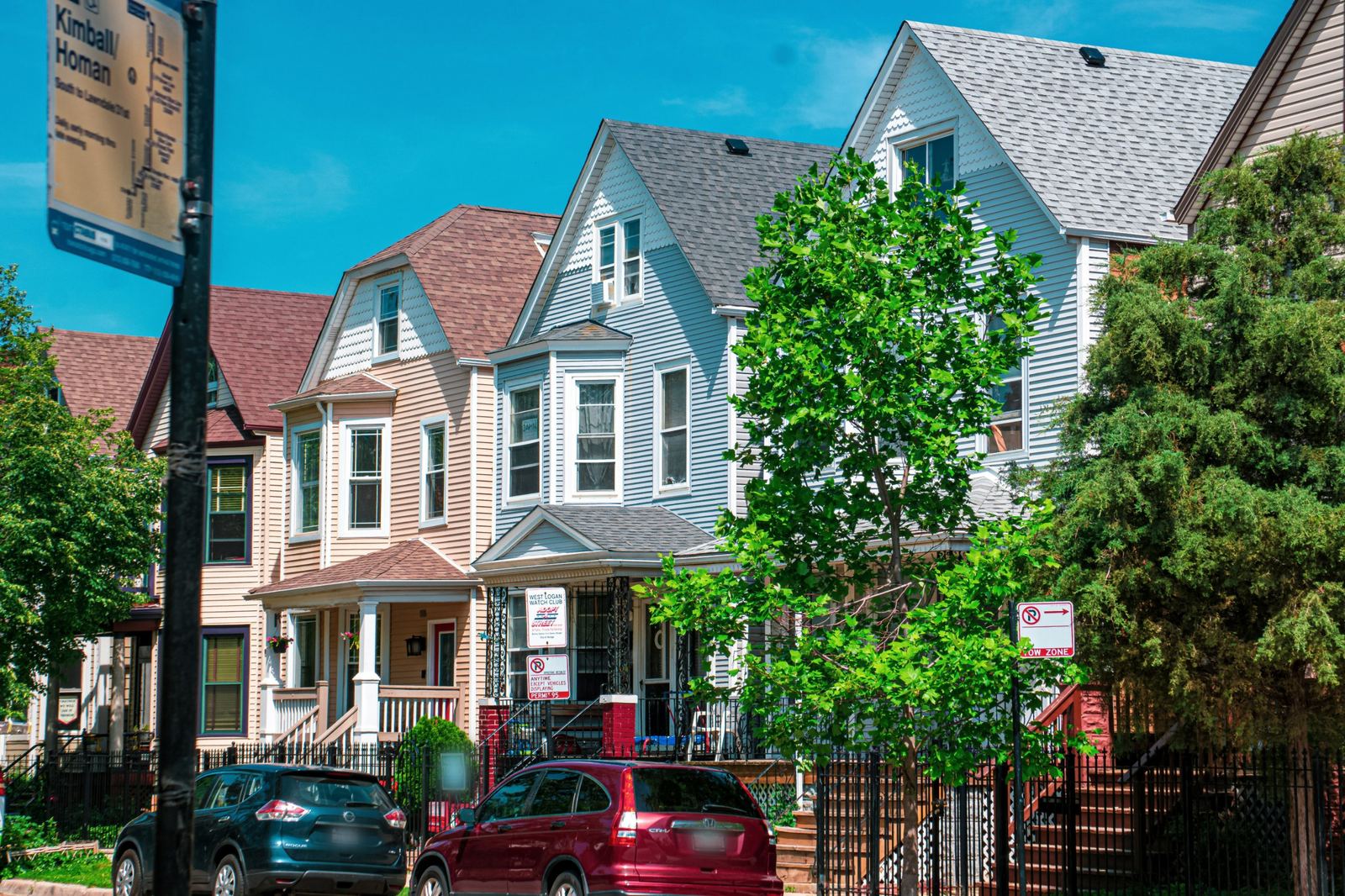 Frame houses and two-flats on a tree-lined residential street near Kimball and Homan on Chicago's Northwest Side